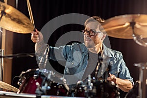 Male musician playing drums and cymbals at concert