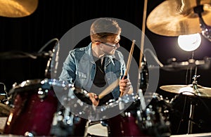 Male musician playing drums and cymbals at concert