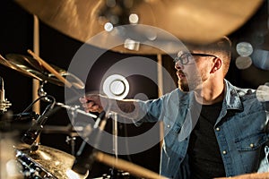 Male musician playing drums and cymbals at concert