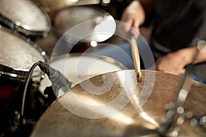 Male musician playing drums and cymbals at concert