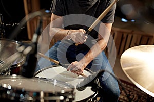 Male musician playing drums and cymbals at concert