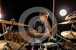 Male musician playing drums and cymbals at concert