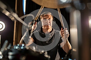 Male musician playing drums and cymbals at concert