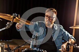 Male musician playing drums and cymbals at concert