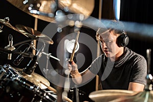 Male musician playing drums and cymbals at concert