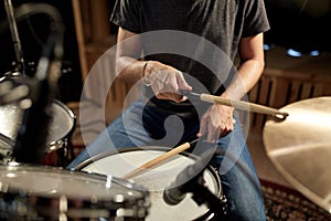 Male musician playing drums and cymbals at concert