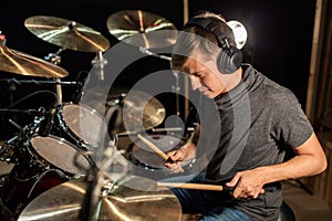 Male musician playing drums and cymbals at concert