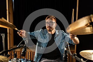 Male musician playing drums and cymbals at concert