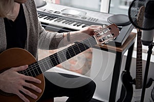 Male musician tuning his guitar