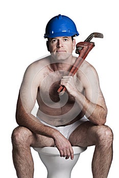 Male with naked torso, bue helmet and wrench