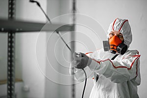 Male in an NBC personal protective equipment ppe suit cleaning  space