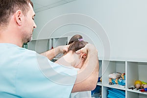 Male neurologist doctor examines cervical vertebrae of female patient spinal column in medical clinic. Neurological physical exami