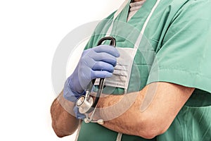 Male nurse or doctor dressed in green scrubs with stethoscope in hand on white background