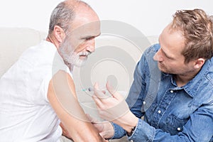 Male nurse setting an injection