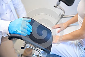 Male nurse standing near patient in clinic