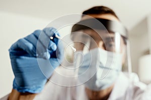 Male nurse taking a nasopharyngeal culture photo