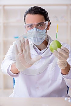 Male nutrition expert testing food products in lab