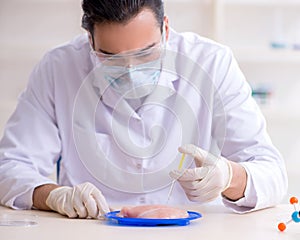 Male nutrition expert testing food products in lab