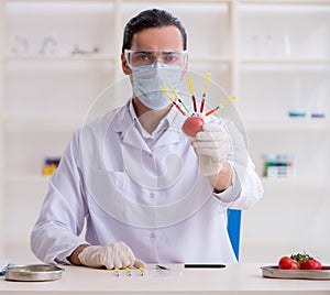 Male nutrition expert testing food products in lab