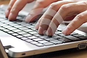 Male office worker typing on keyboard