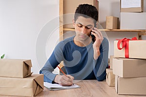 male online seller confirming orders from customer by phone, arab online store small business owner taking order by