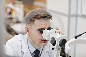 Male Ophthalmologist Using Vision Test Equpment