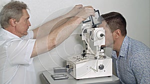 Male optician examining patient`s eye pressure