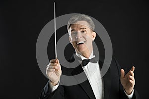 Male Orchestra Conductor Looking Away While Directing photo