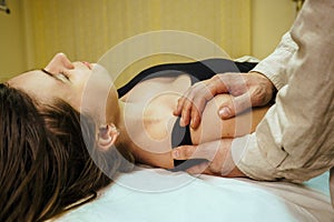 male osteopath conducts a CST treatment session for a woman 5