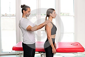Male osteopath doing a postural evaluation