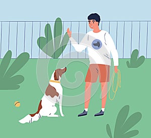 Male owner training his dog to command sit. Trainer teach obedient purebred spaniel in park. Cheerful man or cynologist photo