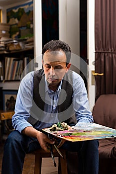 Male painter holding a colorful artists palette