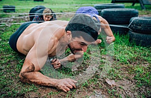 Male participant in an obstacle course crawling