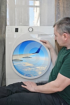 A Male Passenger Looking Through A Washing Mashine Window Like A Plane