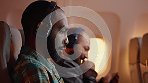 Male passenger working on laptop and travelling by plane