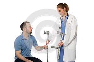 Male Patient Gets Crutches from Woman Doctor