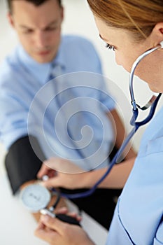 Male patient getting his blood pressure taken