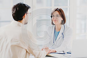 Male patient has consultation with female doctor, receives support, finds out about serious disease. Woman therapist comforts ill