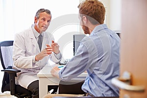 Male Patient Having Consultation With Doctor In Office photo