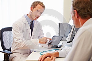 Male Patient Having Consultation With Doctor In Office