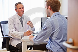 Male Patient Having Consultation With Doctor In Office photo