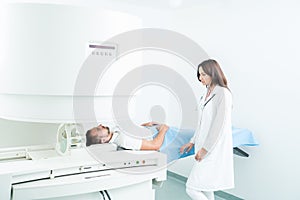 Male Patient In Hospital Bed, getting visited by female doctor t