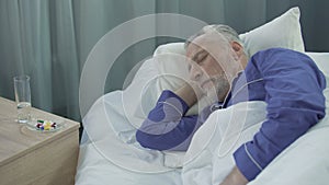 Male patient napping in hospital ward, seeing dreams and talking in sleep