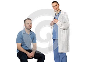 Male Patient Sitting with Standing Female Doctor