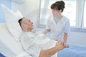 Male patient talking to female nurse in emergency room