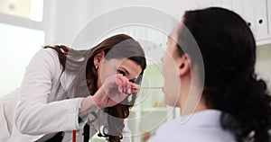 Male patient undergoes throat examination in clinic