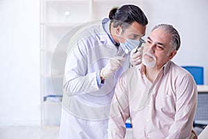 Male patient visiting doctor otolaryngologist