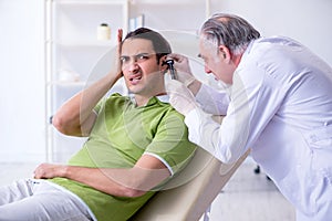 Male patient visiting doctor otolaryngologist