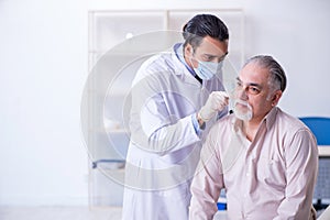 Male patient visiting doctor otolaryngologist