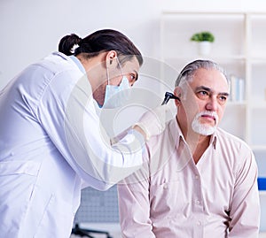 Male patient visiting doctor otolaryngologist